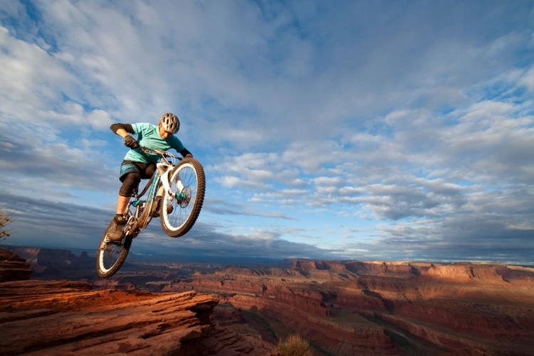 Joe-McNally-Ambassador-mountain-biker-over-canyon
